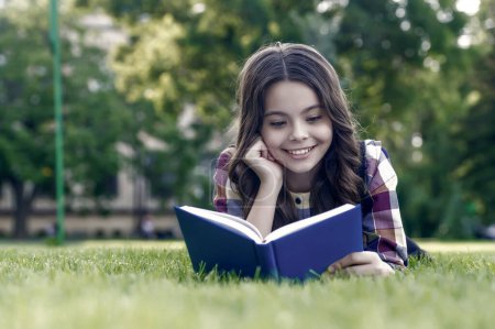 Photo for To succeed you must read. Happy kid read book lying on green grass. School library. Literacy education. Home reading. Literature lesson. Learning foreign language. English school. Worth spending time. - Royalty Free Image