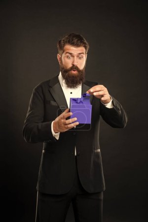 Photo for Surprised man in tuxedo bow tie formalwear on black background with box. valentines day. - Royalty Free Image