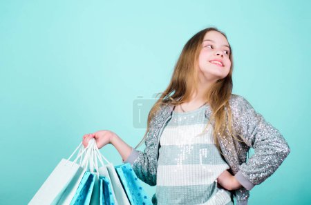 Photo for Clearance sale. Sales and discounts. Small girl with shopping bags. special offer. Holiday purchase saving. Happy child. Little girl with gifts. Kid fashion. shop assistant. clearance sale concept. - Royalty Free Image