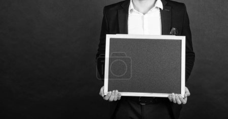 Photo for Professional man crop view hold empty school blackboard copy space dark background, education. - Royalty Free Image