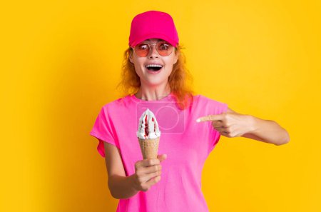 Photo for Summer woman with yummy cone in studio, pointing finger. summer woman with yummy cone on background. photo of summer woman with yummy cone. summer woman with yummy cone isolated on yellow. - Royalty Free Image
