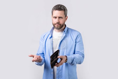 Photo for Shrugging broke man with wallet isolated on studio background. broke man with wallet in studio. broke man with wallet at hand. photo of broke man with wallet. - Royalty Free Image