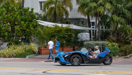 Photo for Miami Beach, Florida USA - March 19, 2021: blue polaris slingshot in miami, side view. three-wheeled motorcycle. - Royalty Free Image