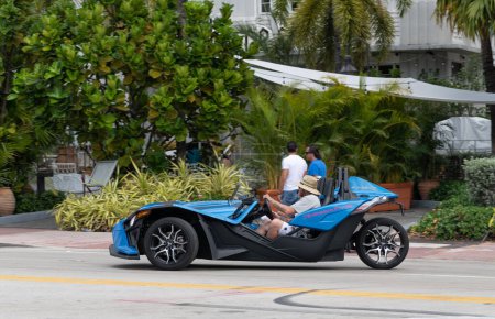 Téléchargez les photos : Miami Beach, Florida USA - March 19, 2021: blue polaris slingshot on road, side view. three-wheeled motorcycle. - en image libre de droit