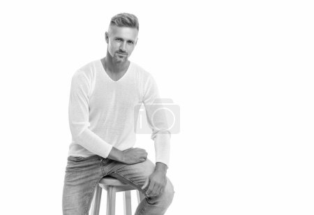 Photo for Smiling handsome mature guy with graying hair sit on chair isolated on white background with copy space, mens beauty. - Royalty Free Image