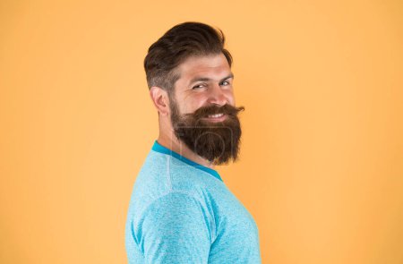 Photo for Bring your hair to the next level. Happy hipster with long beard and stylish hair on yellow background. Bearded man with unshaven face hair. Brutal guy with shaped beard and mustache hair. - Royalty Free Image