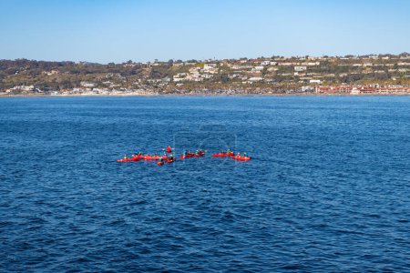 Photo for San Diego, USA - March 28, 2021: group of tourists paddling in tandem kayaks in blue sea water. - Royalty Free Image
