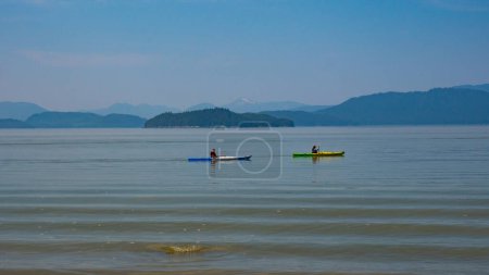 Photo for Kayakers kayaking on kayaks. People paddling in kayaks on lake. Sea kayaking. Water sport activity. Kayaking. Adventure. - Royalty Free Image