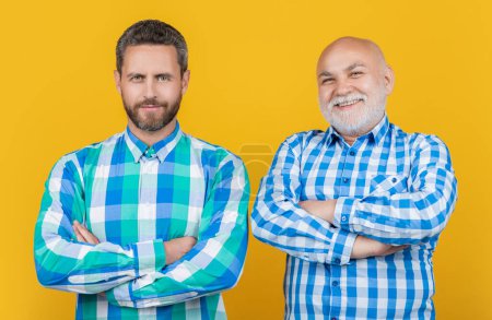 Photo for Two generation family men isolated on yellow. two generation family men in studio. two generation family men on background. photo of two generation family men wear checkered shirt. - Royalty Free Image