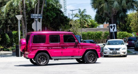 Photo for Miami Beach, Florida USA - April 15, 2021: pink metallic mercedes g63 AMG by impressive wrap, side view. - Royalty Free Image