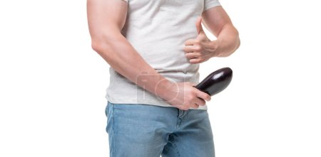Man crop view giving thumb holding eggplant at crotch level imitating erect penis isolated on white.