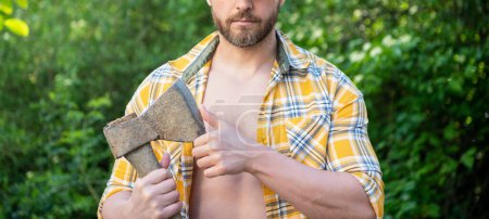 Photo for Cropped view of rancher with axe. rancher with axe wearing checkered shirt. rancher with axe outdoor. photo of rancher with axe. - Royalty Free Image