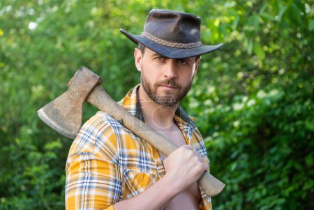 Photo for Portrait of rancher with axe wearing checkered shirt. rancher with axe outdoor. photo of rancher with axe. rancher with axe. - Royalty Free Image