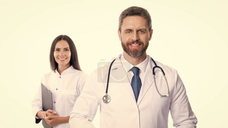 Photo for Selective focus of doctor and nurse wear white coat. nurse and doctor with laptop and anamnesis. doctor and nurse isolated on white background. doctor with nurse in studio. - Royalty Free Image