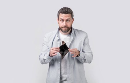 Photo for Amazed moneyless guy with wallet at hand. photo of moneyless guy with wallet. moneyless guy with wallet isolated on studio background. moneyless guy with wallet in studio. - Royalty Free Image