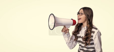 photo of teen girl announcer with megaphone, advertisement. teen girl announcer isolated on white. teen girl announcer in studio. teen girl announcer on background.