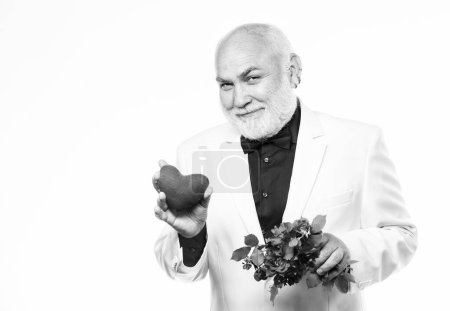 Photo for Anniversary and valentines day. donor transplant. love and romance. Health care treatment. problems with heart. bearded businessman. heart failure. mature man hold flowers and heart. fathers day. - Royalty Free Image