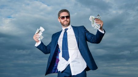 Photo for Photo of millionaire man with money banknote. millionaire man with money on sky background. millionaire man with money outdoor. millionaire man with money in suit. - Royalty Free Image