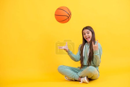 Photo for Teen girl practicing basketball skills. Teen girl excelling in basketball. Skilled teen girl playing the basketball. Competitive teen girl playing basketball. Youthful athleticism in sports. Happy - Royalty Free Image