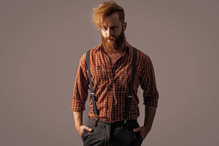 Photo for Photo of charismatic retro hipster man in suspenders. retro hipster man in suspenders isolated on grey. retro hipster man in suspenders at studio. retro hipster man in suspenders on background. - Royalty Free Image