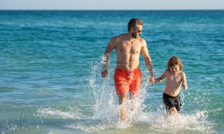 Photo for Family moments between daddy and son at sea, copy space. family day. Father son kid bonding relationship. daddy and son running in sea beach. Father son child bonding enjoying summer vacation. - Royalty Free Image