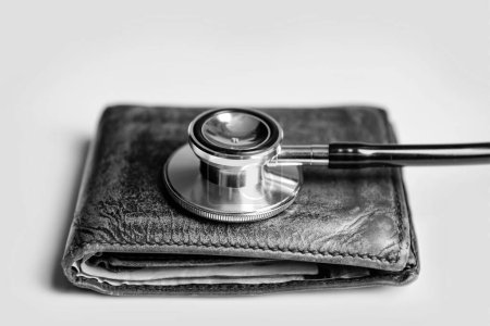 Foto de Closeup of stethoscope and wallet as symbol of medical insurance. life planning and medical insurance. medical insurance concept. - Imagen libre de derechos
