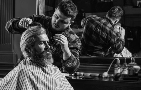 Foto de Ambitious. male beauty and fashion. mature man at barbershop. brutal bearded man at hairdresser. professional barber with male client. hipster with dyed beard and moustache. man want new hairstyle. - Imagen libre de derechos