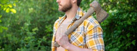 Photo for Cropped photo of rancher with axe. rancher with axe. rancher with axe wearing checkered shirt. rancher with axe outdoor. - Royalty Free Image