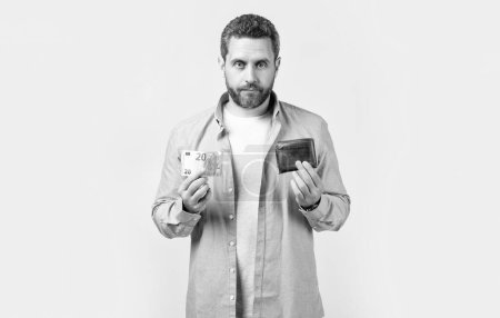 Photo for Unemployed moneyless man with wallet in studio. moneyless man with wallet at hand. photo of moneyless man with wallet. moneyless man with wallet isolated on studio background. - Royalty Free Image