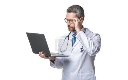 Photo for Photo of busy emedicine and doctor man with laptop. doctor promoting emedicine isolated on white. doctor offering emedicine in studio. doctor presenting emedicine on background. - Royalty Free Image