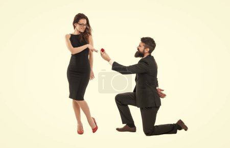 Photo for He will never let her go. happy valentines day. tuxedo couple formal event. couple in love celebrate engagement. wedding party. man on one knee making marriage proposal. Will you marry me. i said yes. - Royalty Free Image