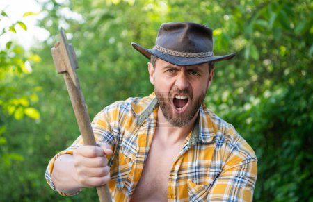 Photo for Image of angry lumberjack with axe. angry lumberjack with axe. angry lumberjack with axe wearing checkered shirt. angry lumberjack with axe outdoor. - Royalty Free Image