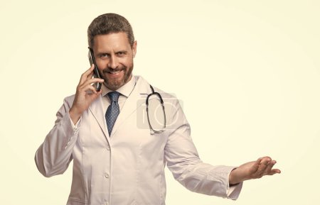 Photo for Photo of cheerful physician online with phone. physician online isolated on white. physician online in studio. physician online on background. - Royalty Free Image