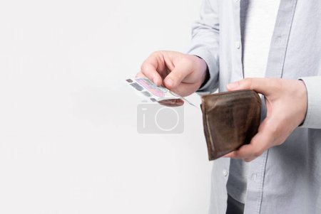 Photo for Moneyless man with wallet isolated on studio background with copy space. moneyless man with wallet in studio. moneyless man with wallet at hand. photo of moneyless man with wallet. - Royalty Free Image