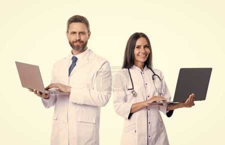 Photo for Happy doctor and nurse online isolated on white. emedicine with doctor with nurse online in studio. photo of doctor and nurse offer online emedicine. nurse and doctor with laptop for emedicine. - Royalty Free Image