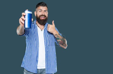 cheerful bearded man hold beauty product bottle of shampoo. thumb up.