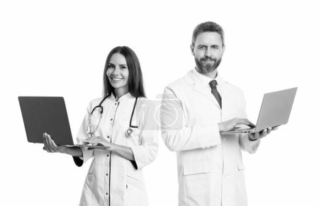 Photo for Happy doctor and nurse online isolated on white. emedicine with doctor with nurse online in studio. photo of doctor and nurse offer online emedicine. nurse and doctor with laptop for emedicine. - Royalty Free Image