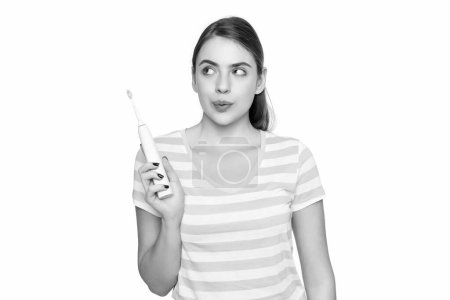 Téléchargez les photos : Funny young woman with electric toothbrush isolated on white background. - en image libre de droit
