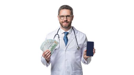 Photo for Photo of medical man show telehealth on screen with money. medical man show telehealth isolated on white. medical man show telehealth in studio. medical man show telehealth on background. - Royalty Free Image