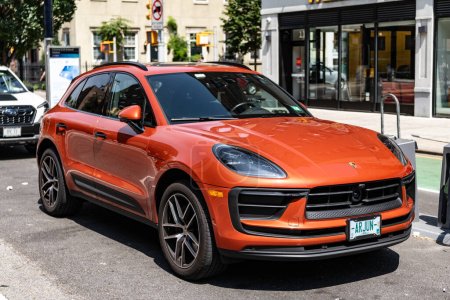 Photo for New York City, USA - August 05, 2023: 2023 Porsche Macan T SUV Ruby red car front and side view, parked. - Royalty Free Image