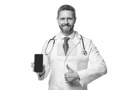 Photo for Medical application. happy doctor presenting medical phone application. emedicine in your phone. thumb up. - Royalty Free Image