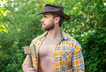 Photo for Man with hatchet. man with hatchet wearing checkered shirt. man with hatchet outdoor. photo of man with hatchet. - Royalty Free Image
