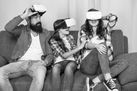 Foto de Father mother and child wireless glasses. virtual reality family. happy parents with kid girl use modern technology. mom dad and daughter. digital future and innovation. modern life. - Imagen libre de derechos