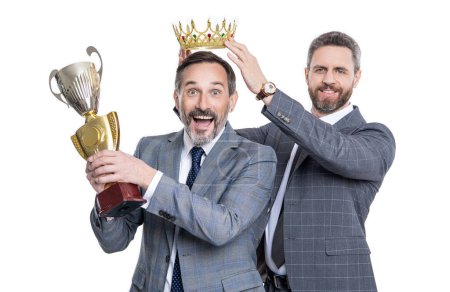 businessman rewarded for business success and successful leadership with champion cup and crown in suit isolated on white.