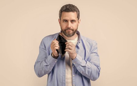 Photo for Moneyless guy with empty wallet in studio. moneyless guy with wallet at hand. photo of moneyless guy with wallet. moneyless guy with wallet isolated on studio background. - Royalty Free Image