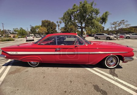 Photo for Los Angeles, California USA - March 28, 2021: red chevrolet impala retro car side view. - Royalty Free Image