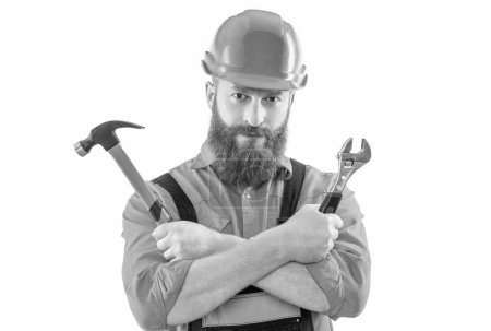 Photo for Mechanic man with hammer and wrench isolated on white. mechanic man wear helmet in studio. mechanic man in uniform on background. photo of mechanic man. - Royalty Free Image