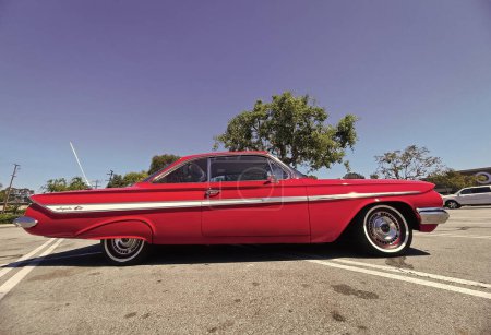 Photo for Los Angeles, California USA - March 28, 2021: red chevrolet impala retro car right side view. - Royalty Free Image