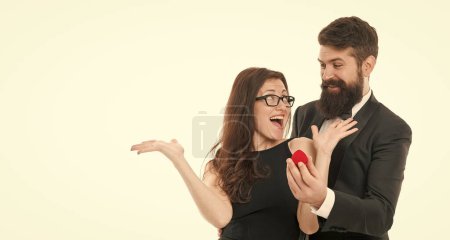 Photo for Cheerful couple. happy valentines day. formal couple in love. man present ring to woman. marry me. offer engagement ring for marriage proposal. celebrate special occasion. tuxedo man and elegant girl. - Royalty Free Image