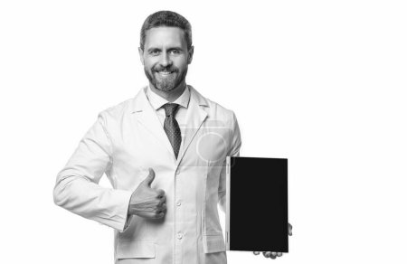 Photo for Photo of ehealth and doctor man with tablet, thumb up. doctor promoting ehealth isolated on white. doctor offering ehealth in studio. doctor presenting ehealth on background. - Royalty Free Image